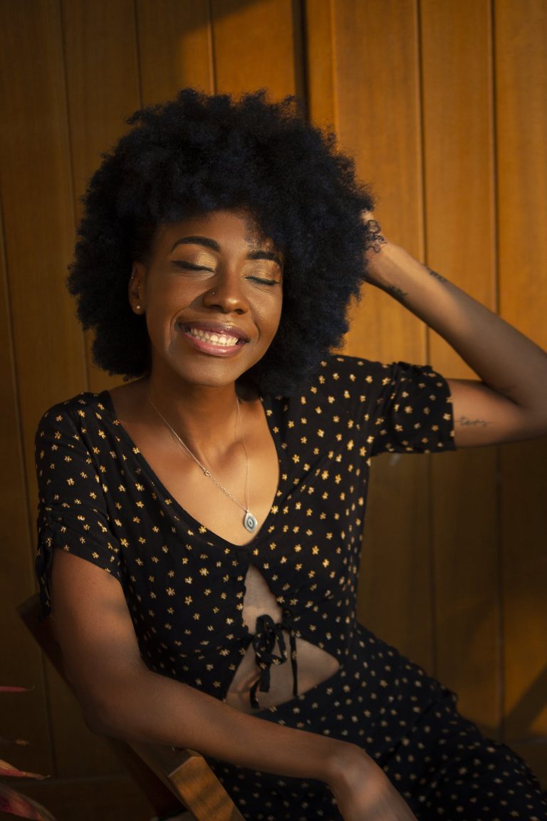 Woman Sitting on Brown Chair