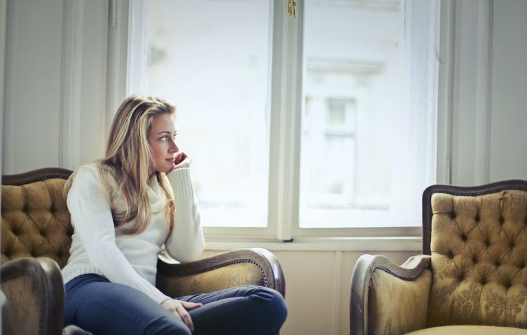 Photography of Woman Sitting on Chair Near Window