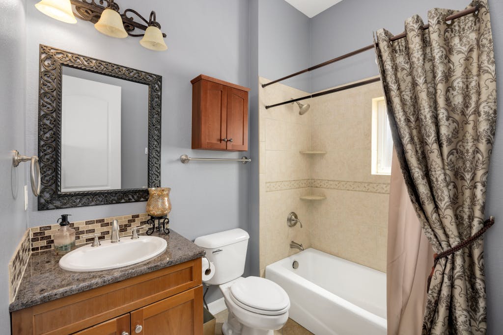 A stylish bathroom featuring modern amenities with classic design elements, perfect for home interiors.