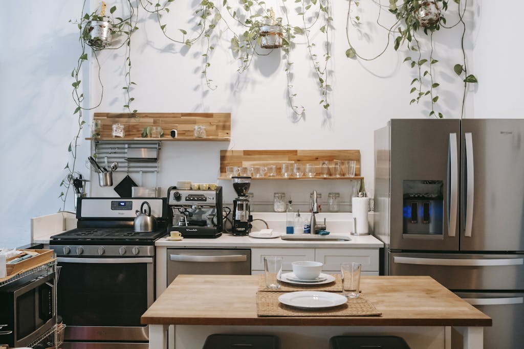 Cozy modern kitchen with stainless steel appliances and countertop decor.