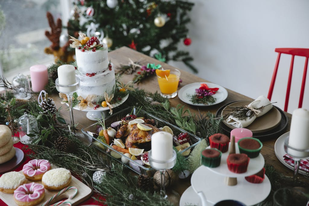 Holiday table setting with festive decorations, candles, and delicious food ready for a Christmas feast.