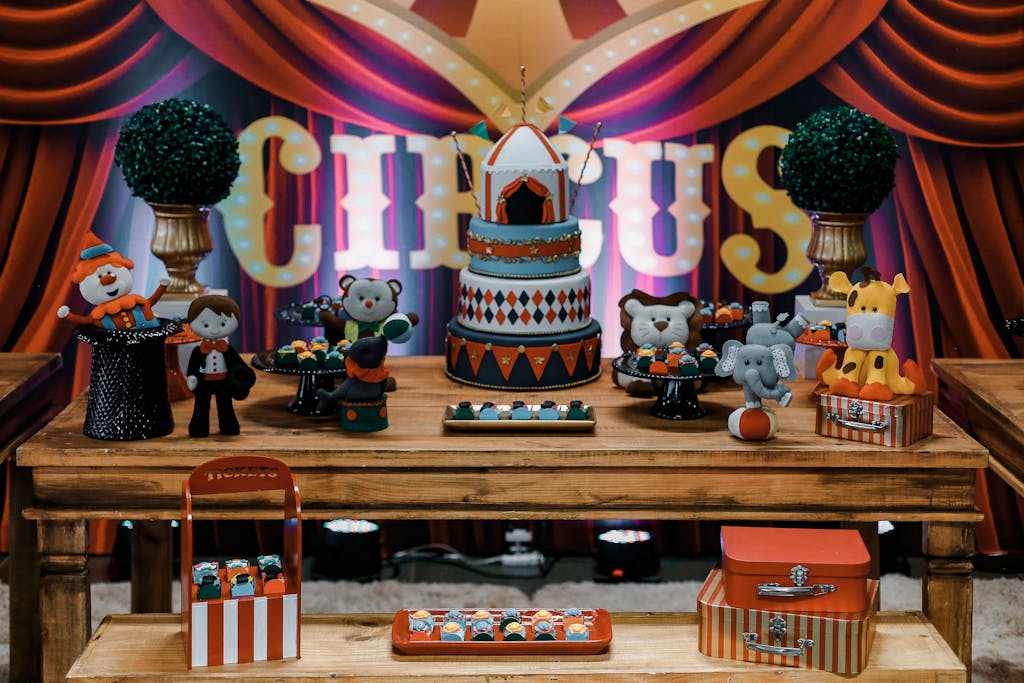 Vibrant circus-themed dessert table with cakes and pastries, perfect for parties.