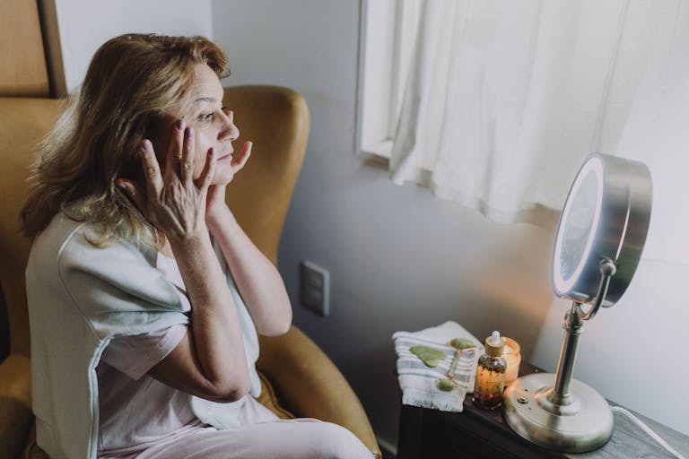 Woman experiencing relaxation with skincare routine at home. Peaceful and soothing atmosphere.