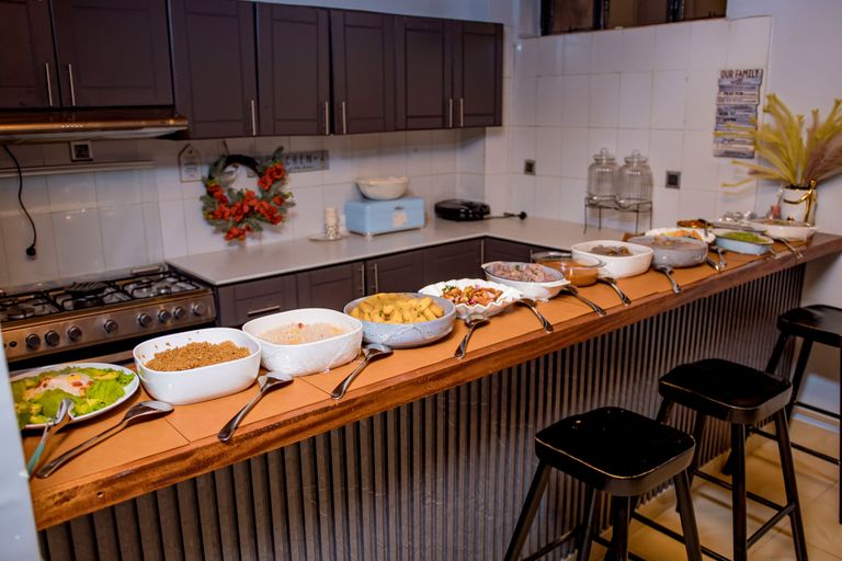Elegant kitchen with a diverse buffet spread, showcasing a variety of dishes for a festive gathering.