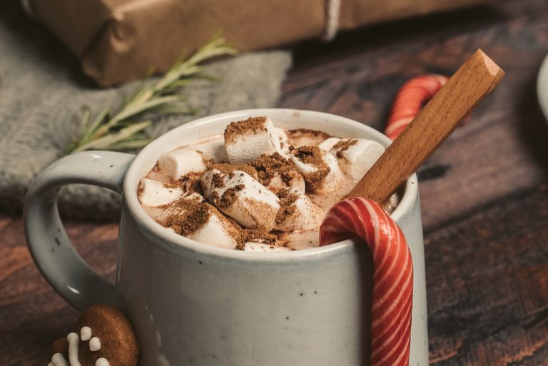 Enjoy a cozy mug of hot chocolate topped with marshmallows and spices, perfect for winter warmth.