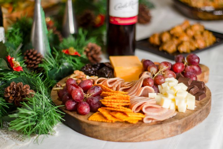 Delicious charcuterie board with assorted cheese, meats, grapes, and crackers, perfect for festive gatherings.